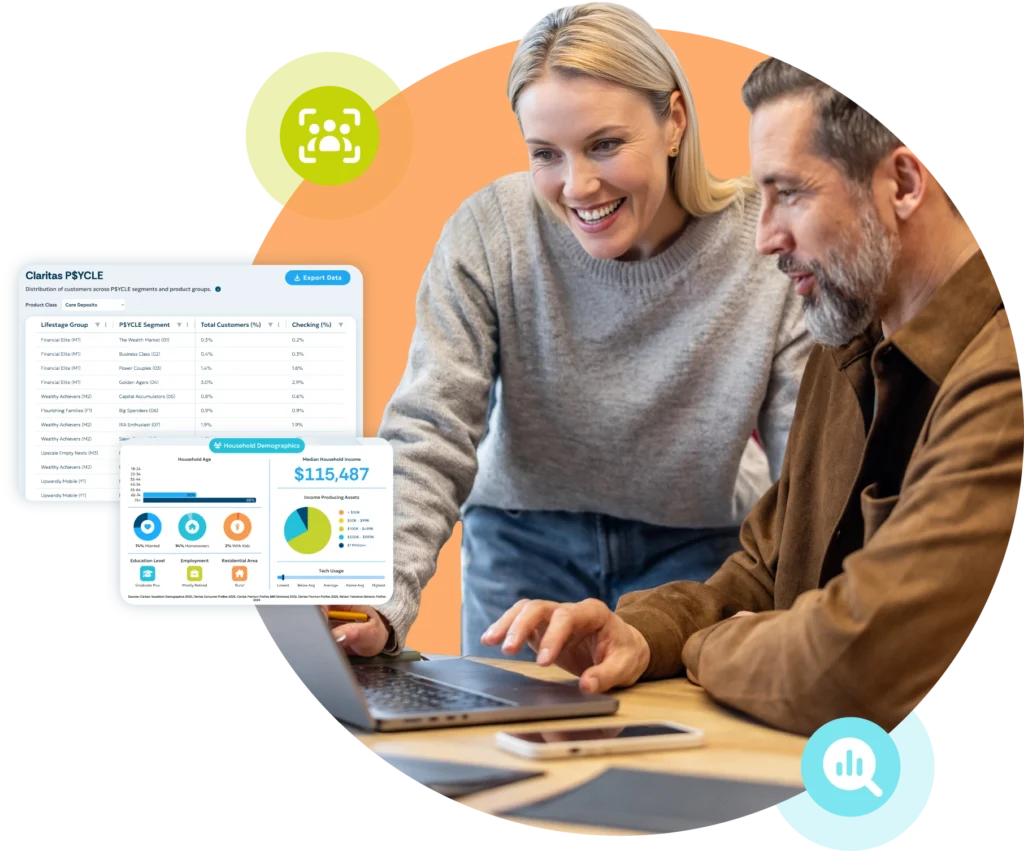 A smiling middle-aged white male and mid-30s white female looking at a laptop.